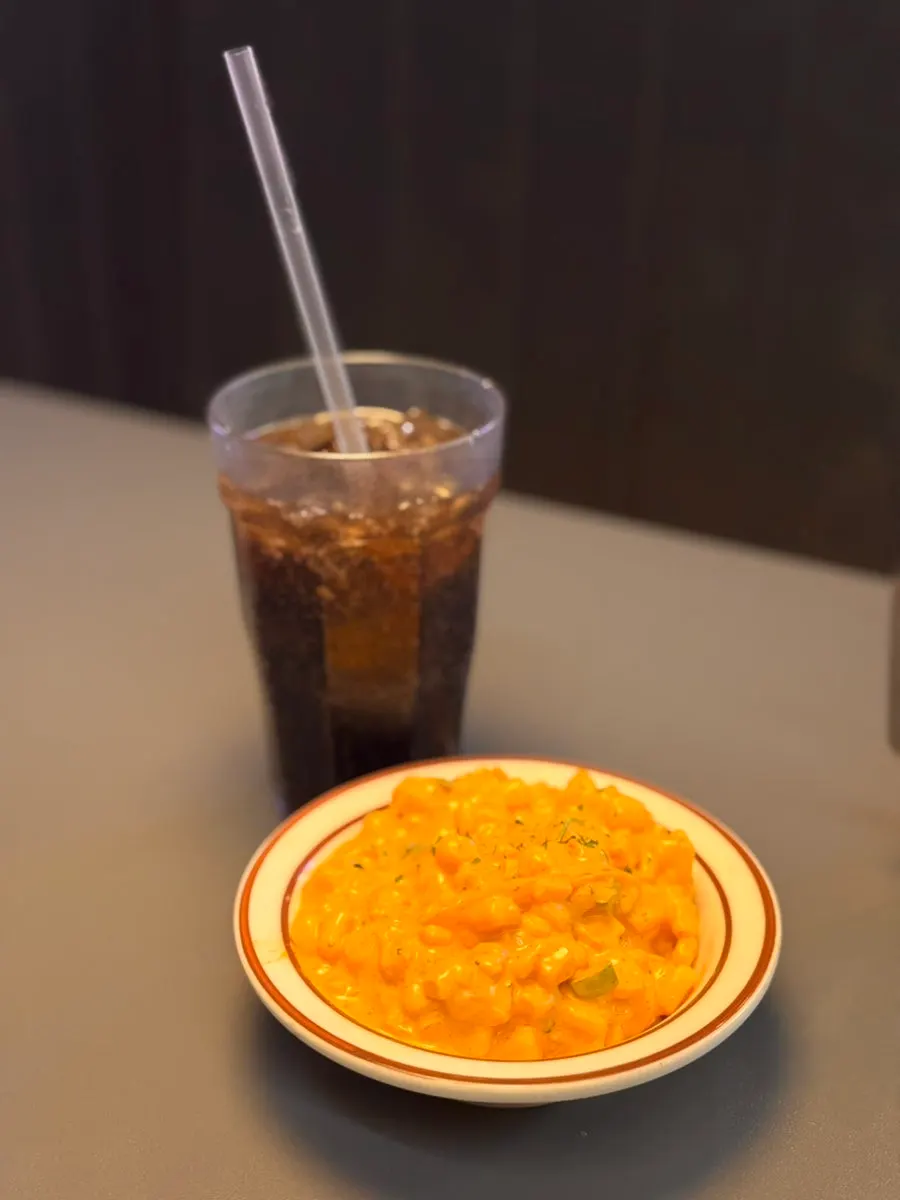 Corn salad placed alongside the burger