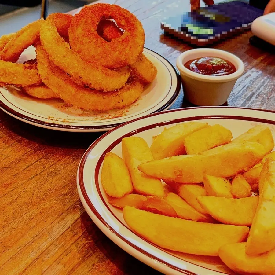 Onion rings and fries together on the table