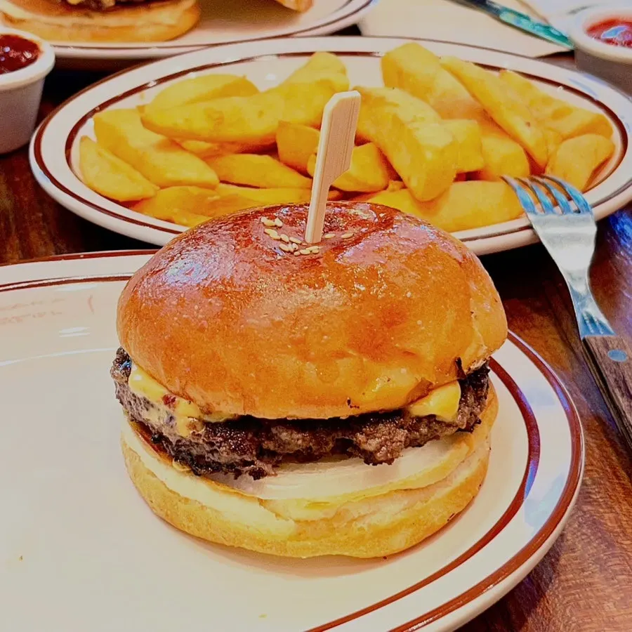 Cross-section of the cheeseburger showing bun, patty, and cheese