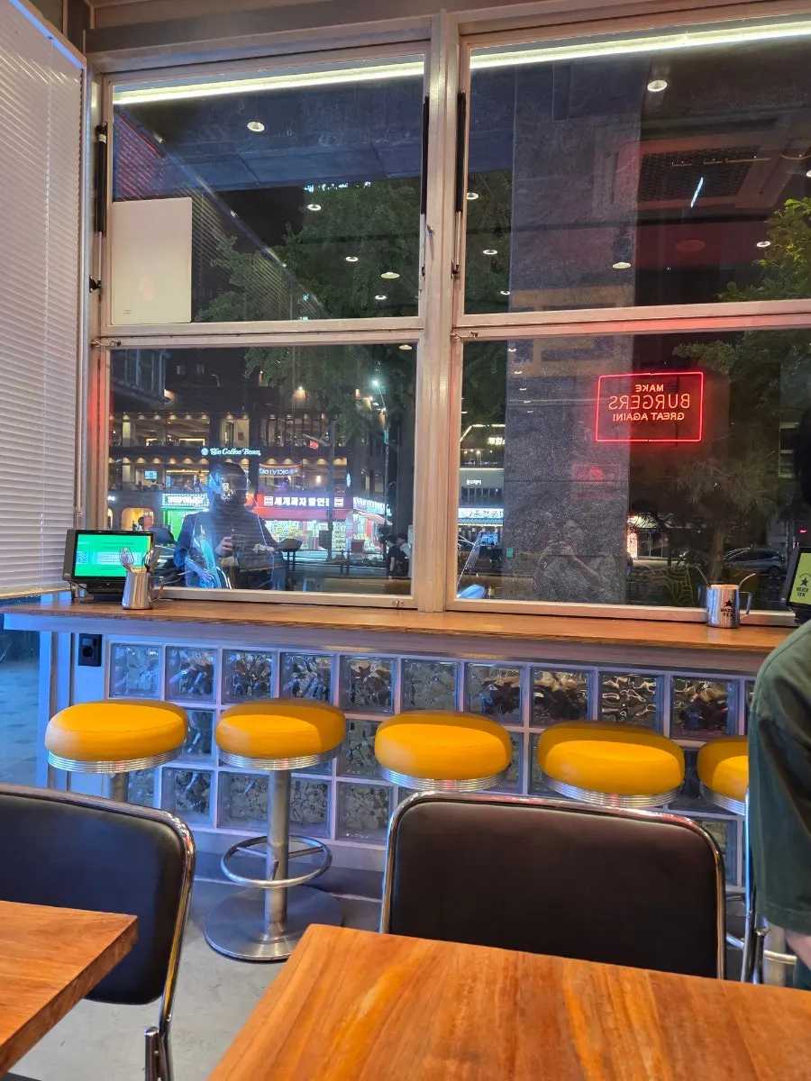 Seating area with a foreign burger joint vibe