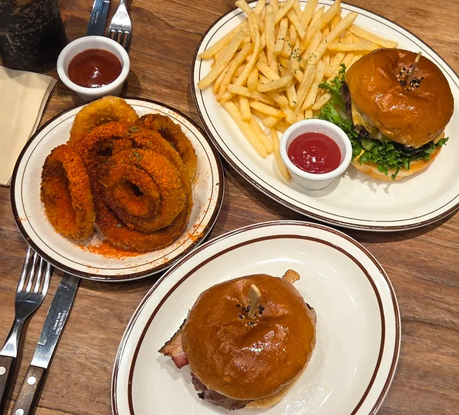 Full spread of burgers and onion rings for two