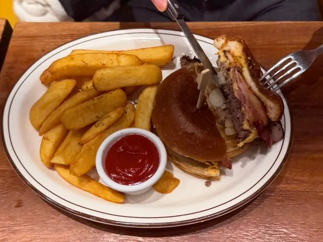 Knife and fork served alongside the burger
