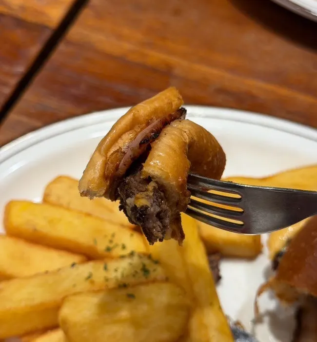 Bacon cheeseburger cut in half with a knife