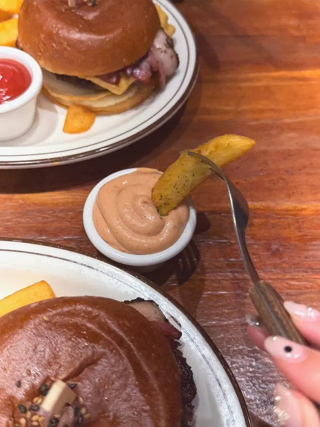 Thick fries dipped into ranch dipping sauce