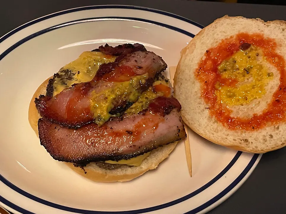 Bun opened to reveal the mustard-based sauce