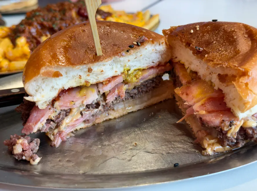 Patty cross-section showing whole-cut bacon and melted cheese