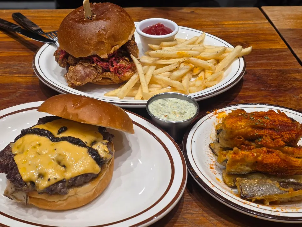 Burgers and sides laid out on the table at Daily Fix Seoul National University Entrance