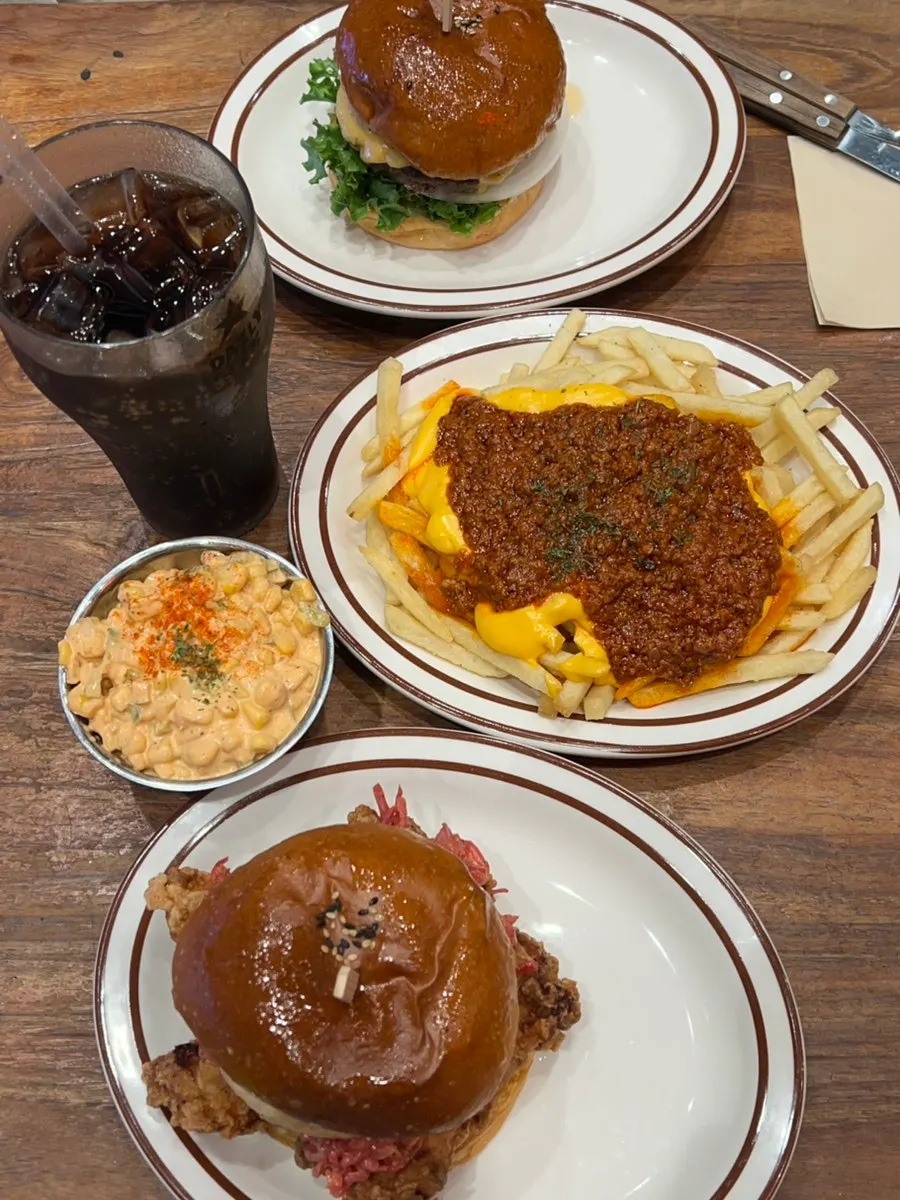 Table with burgers and sides laid out together