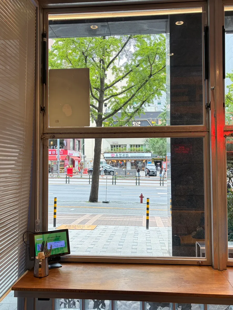 Interior of Daily Fix with floor-to-ceiling windows and wood tables