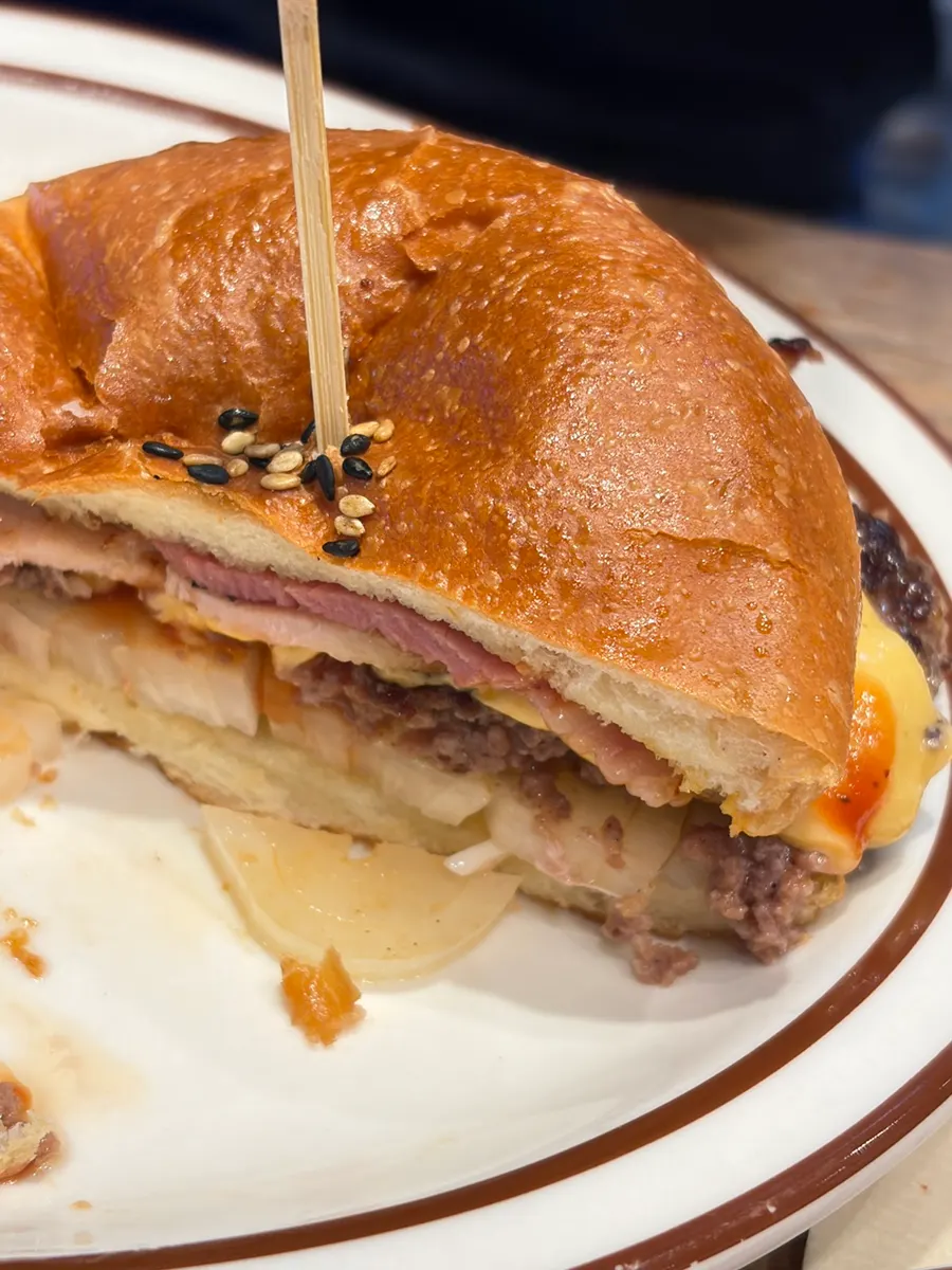 Cheeseburger lifted up for a shot