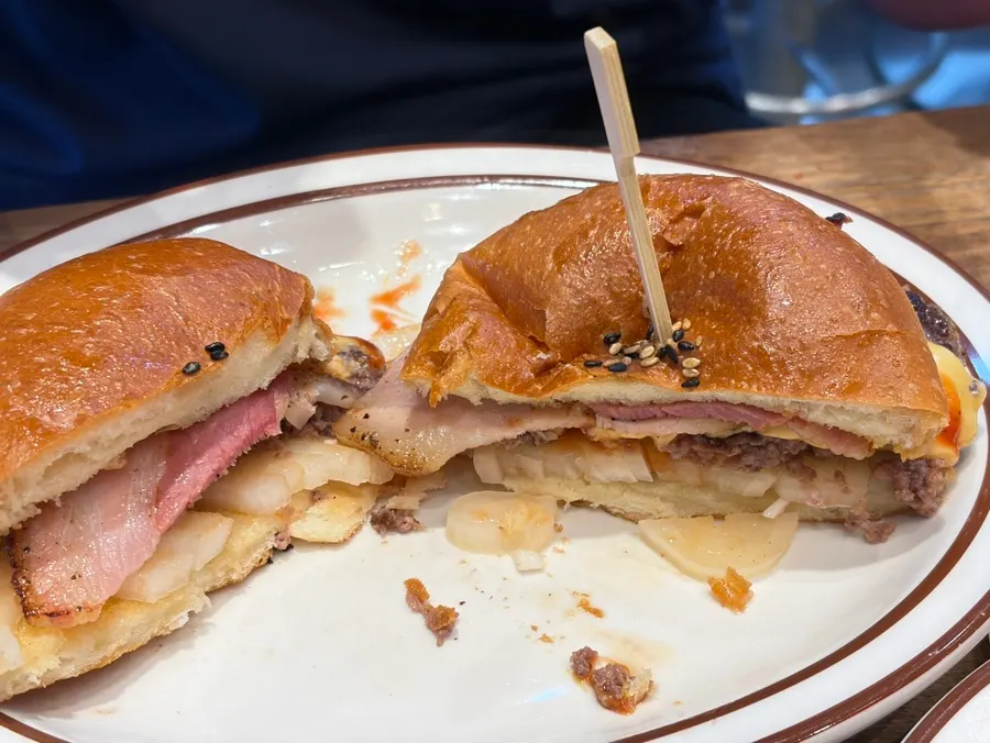 Table with cheeseburger and onion rings together