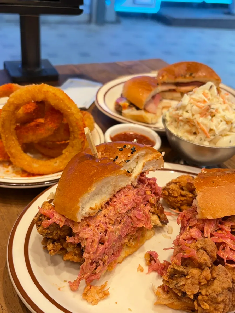 Table full of burgers and sides