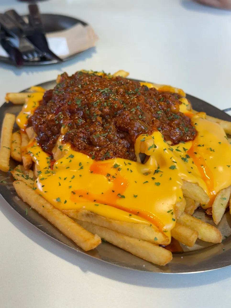 Chili cheese fries at Daily Fix piled high with cheese sauce