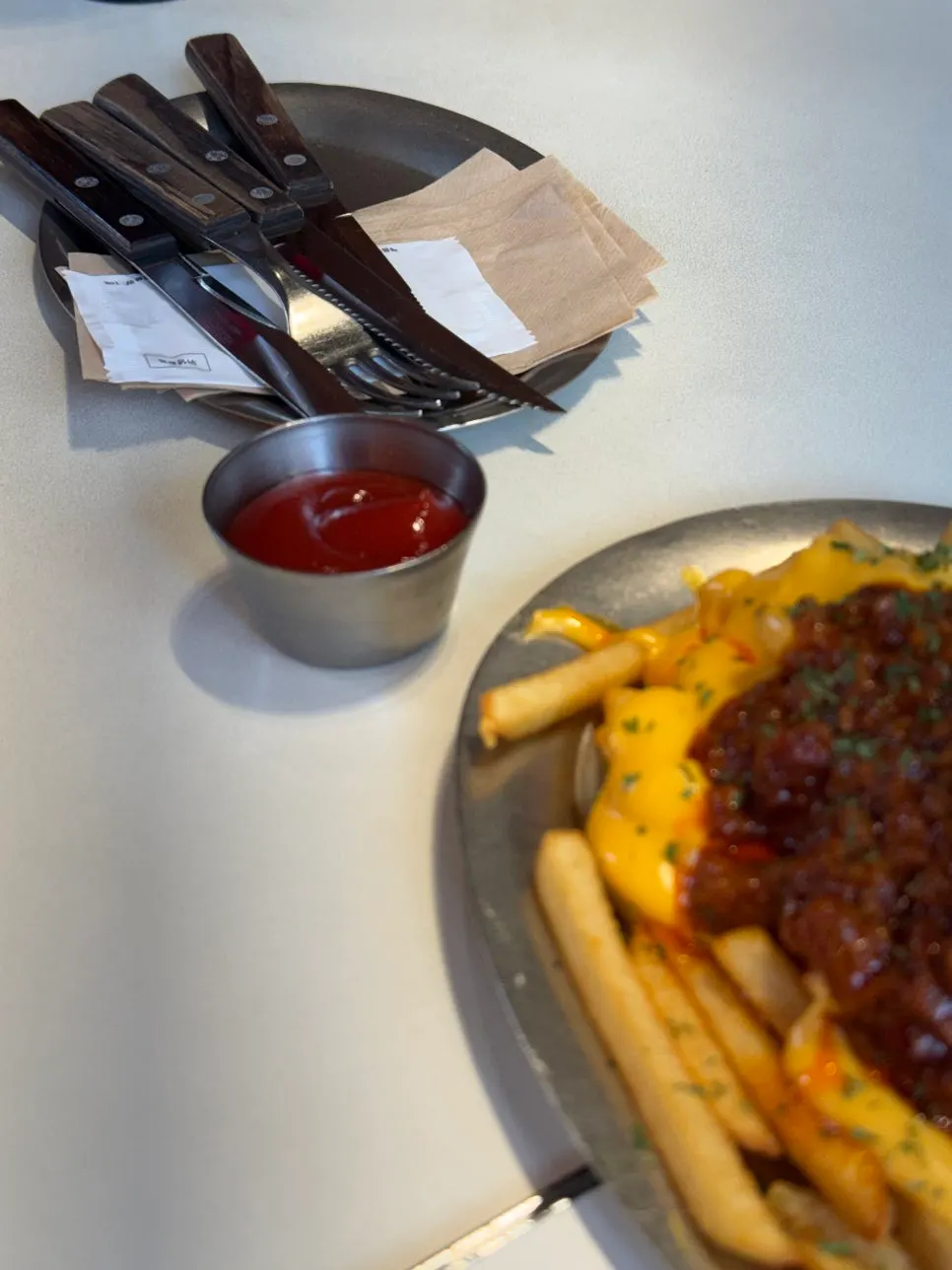 Close-up of fries topped with chili and cheese sauce