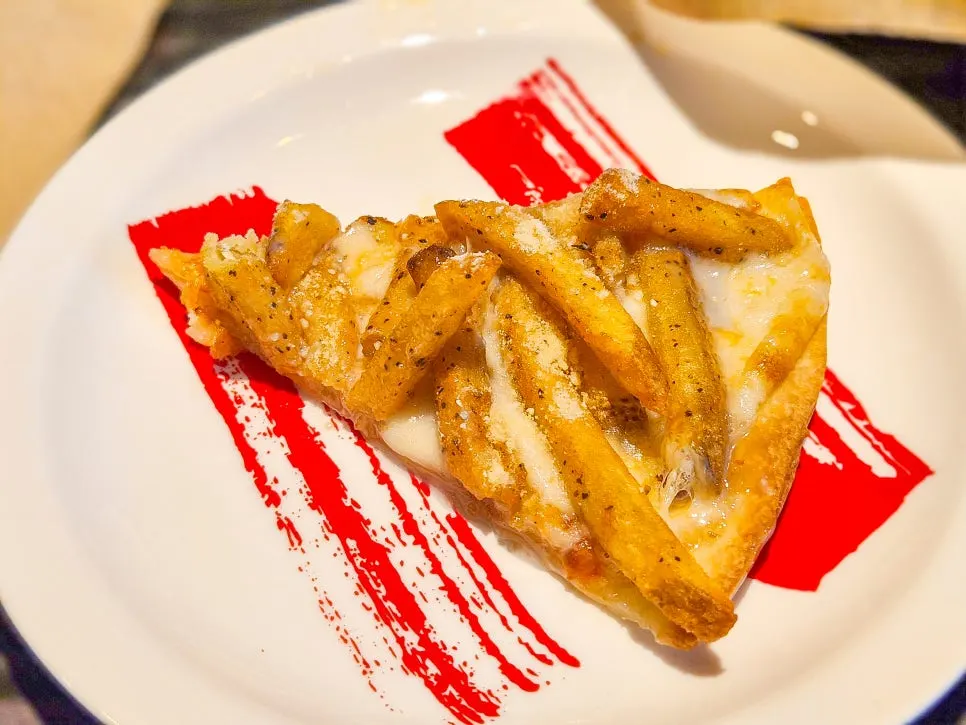 Pizza topped with French fries and condensed milk