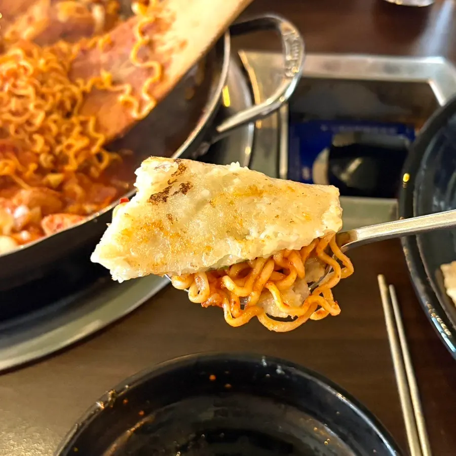 A large potato pancake spilling over the edge of the plate