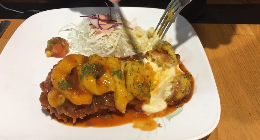 Plate of spicy sweet potato cheese cutlet half eaten