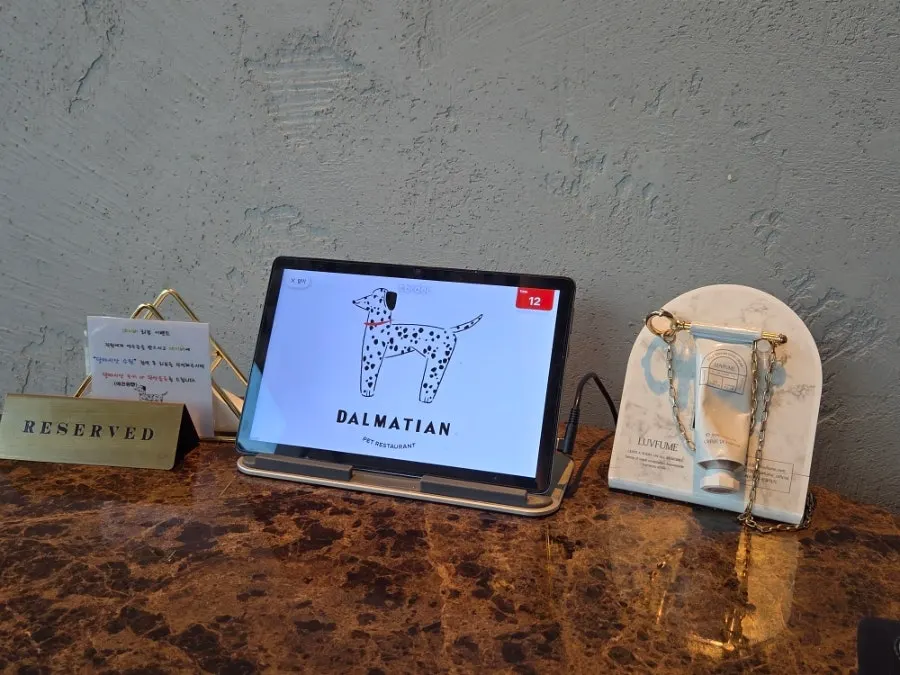 Order-taking tablet and hand cream on the table
