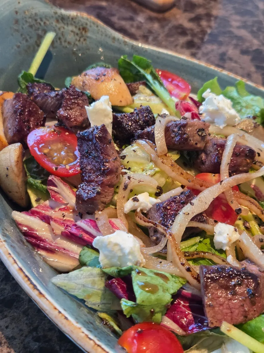 Crunchy vegetables and a piece of steak from the salad