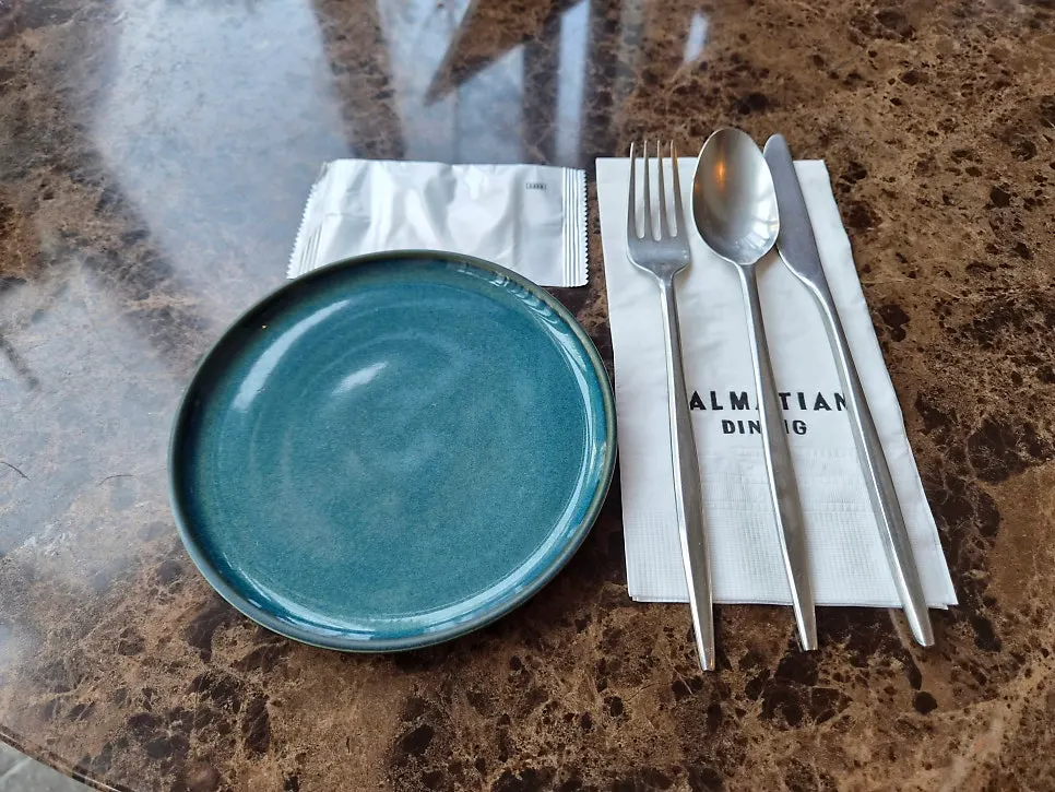 Hand cream and cutlery set at the table