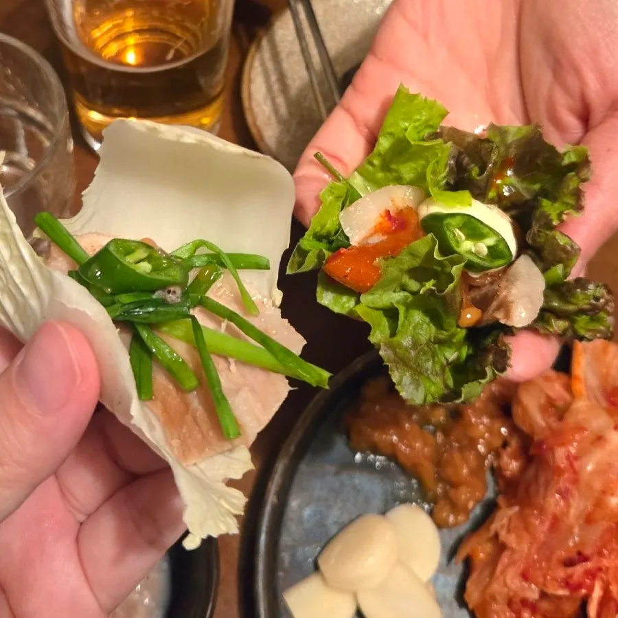 Lettuce wrap topped with pork jowl suyuk and garlic