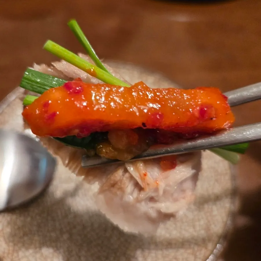 Pork jowl suyuk topped with chives and dried radish