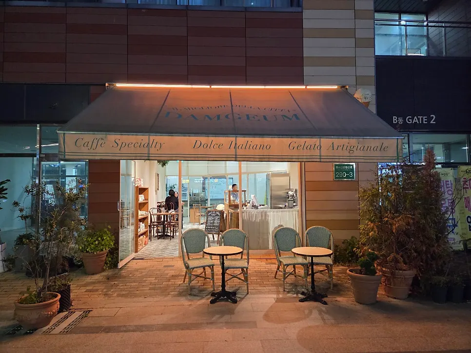 Terrace with a large awning and mint-colored rattan chairs
