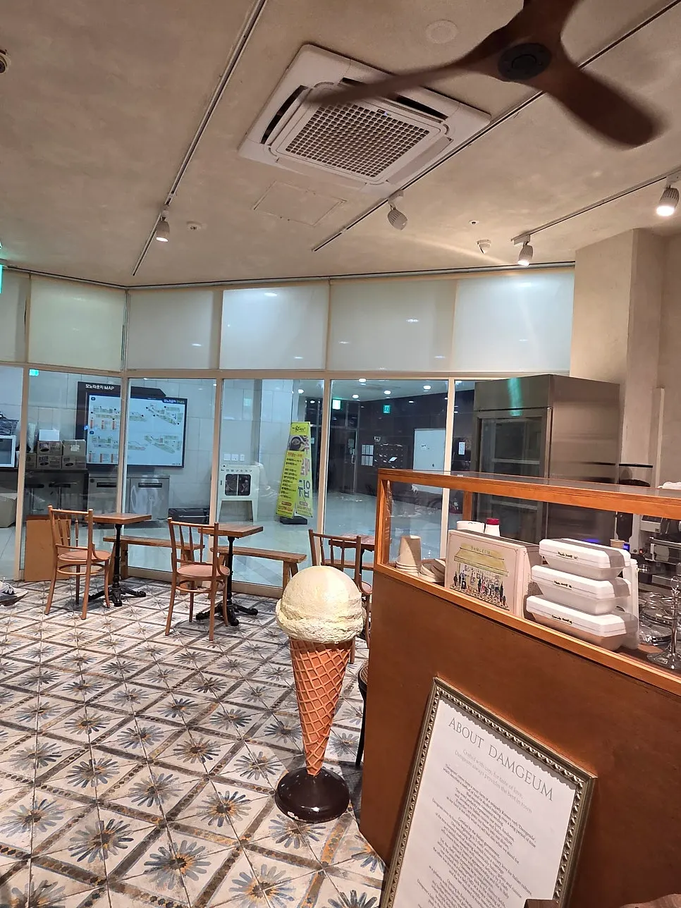 Gelato shop entrance surrounded by potted plants