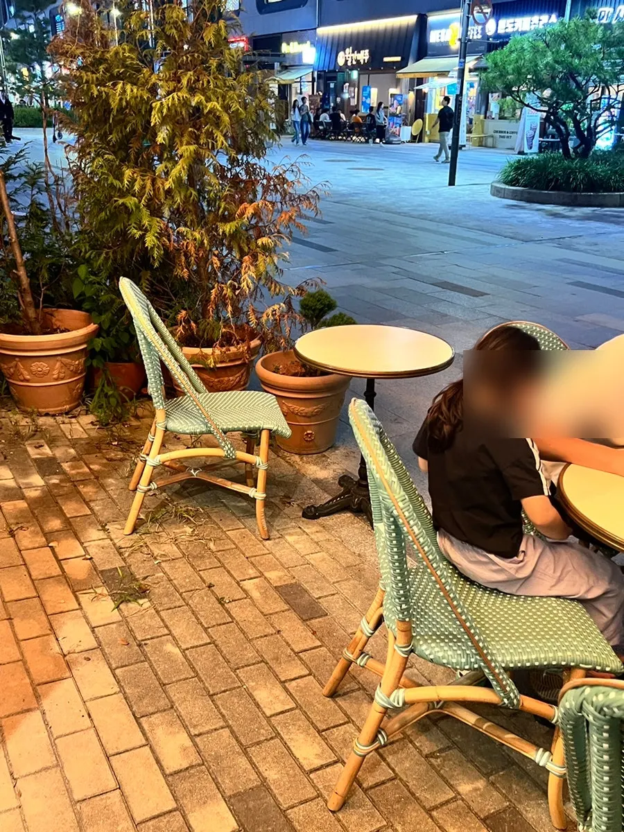 A terrace table with gelato being eaten under the lights