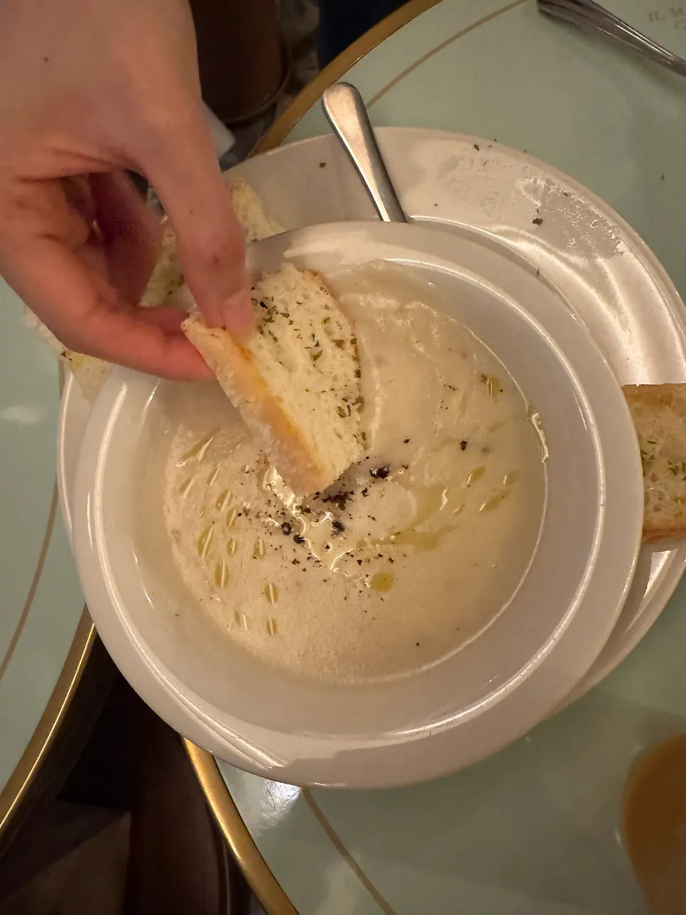 Baguette served alongside the potato soup