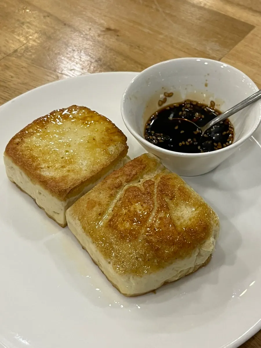 A plate of thick tofu steak
