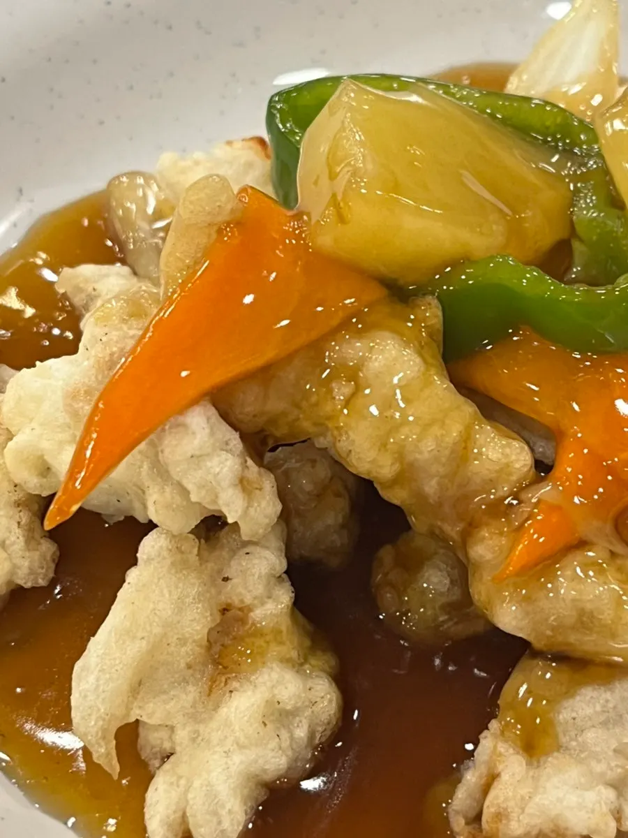 Lotus-leaf sweet and sour pork tossed in sauce