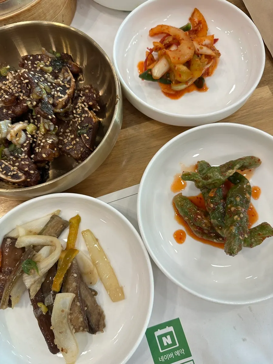 Five side dishes including napa cabbage and cucumber kimchi