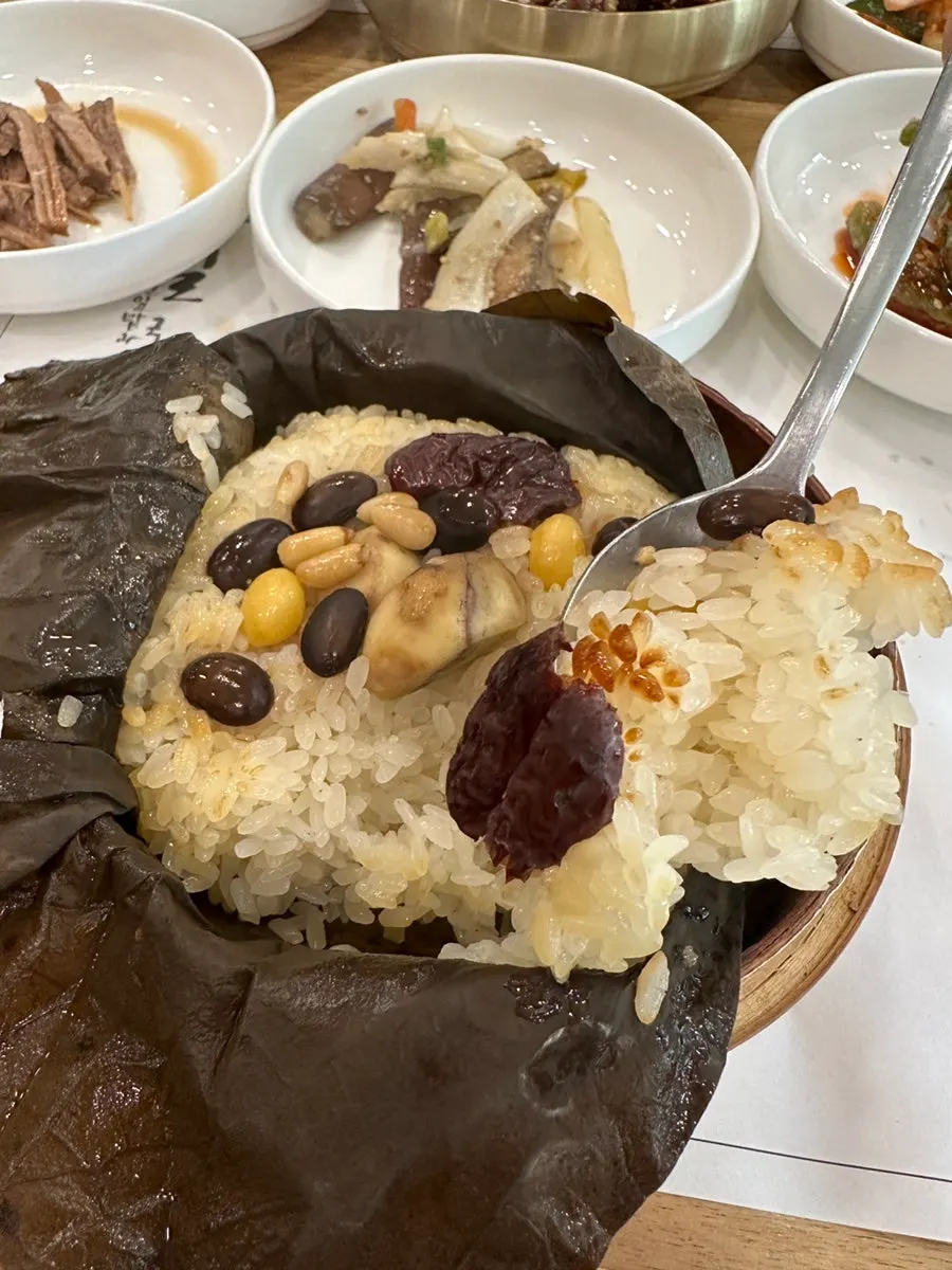 Close-up of lotus leaf rice studded with jujube, chestnuts, and ginkgo nuts
