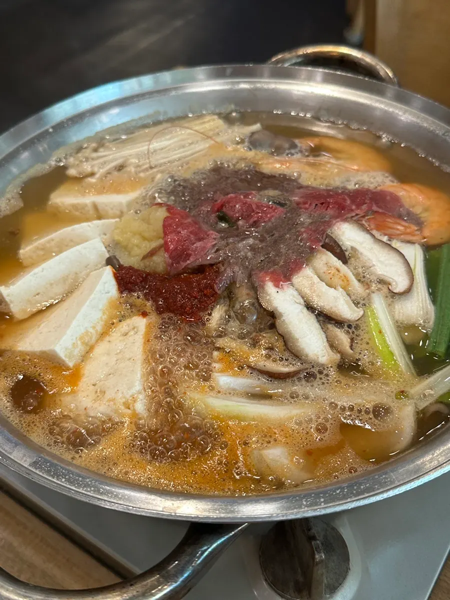 Pot of tofu hot pot served already simmering