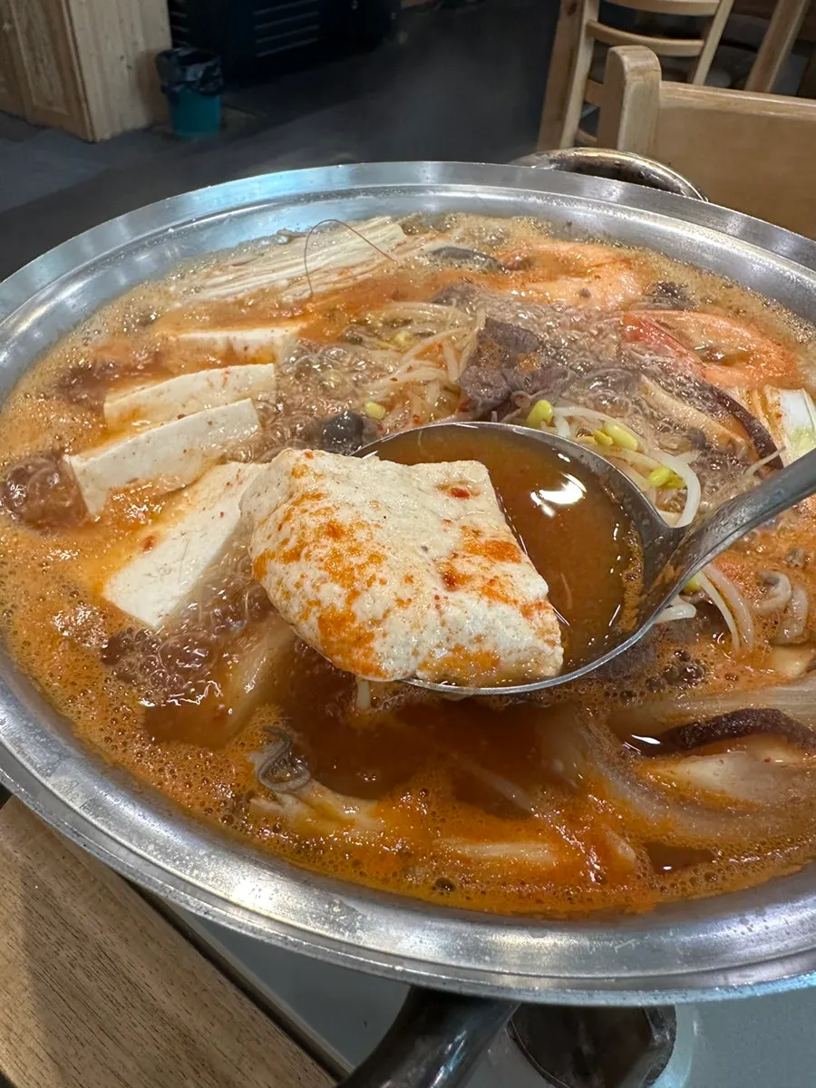 Tofu hot pot topped with shrimp and meat