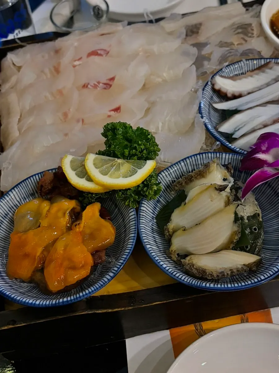 Seafood assortment including sea squirt, conch, and abalone