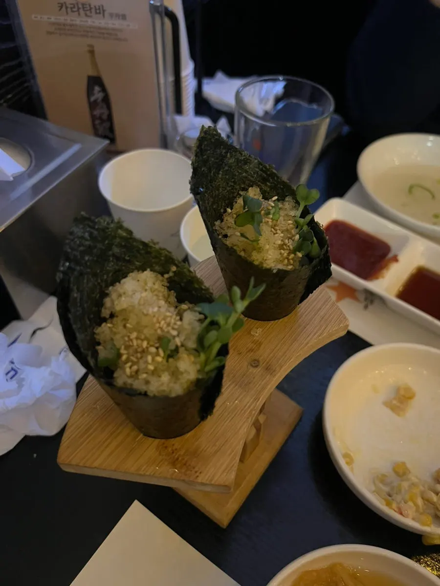 A plate of maki rolls topped with flying fish roe