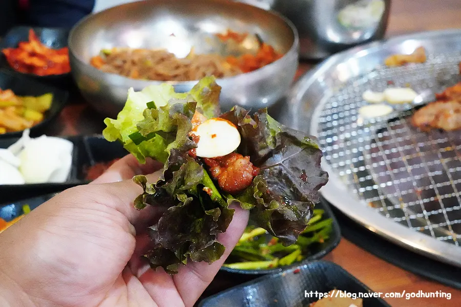 상추에 양념닭갈비와 마늘을 올린 쌈
