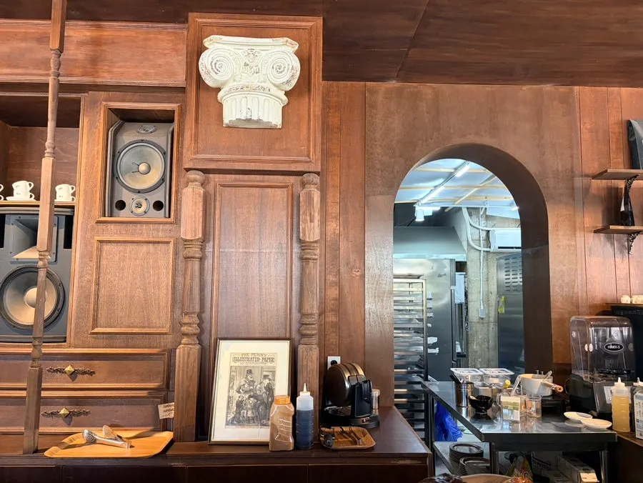 Interior with wood-toned decor, vintage props, and a speaker