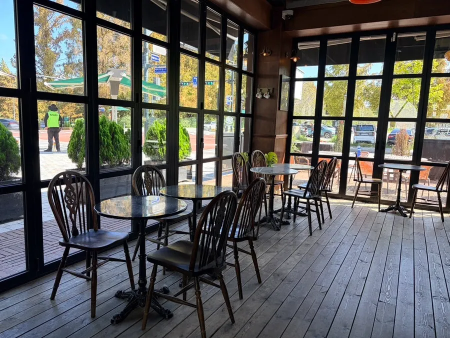Indoor seating at Frank Coffin Bar with sunlight through the windows