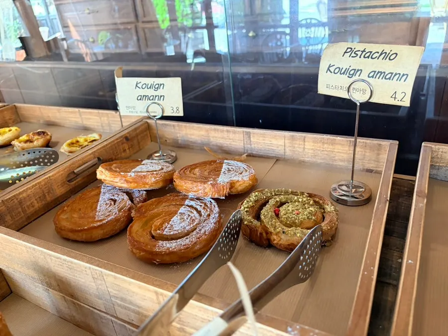 Pistachio kouign-amann on the bakery display stand