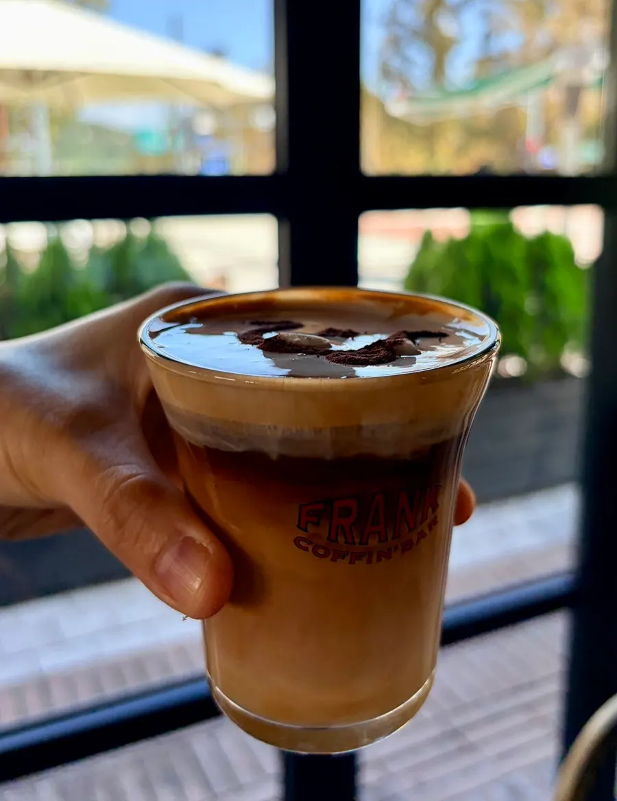 Close-up of cinnamon powder on the Frank Coffee cream