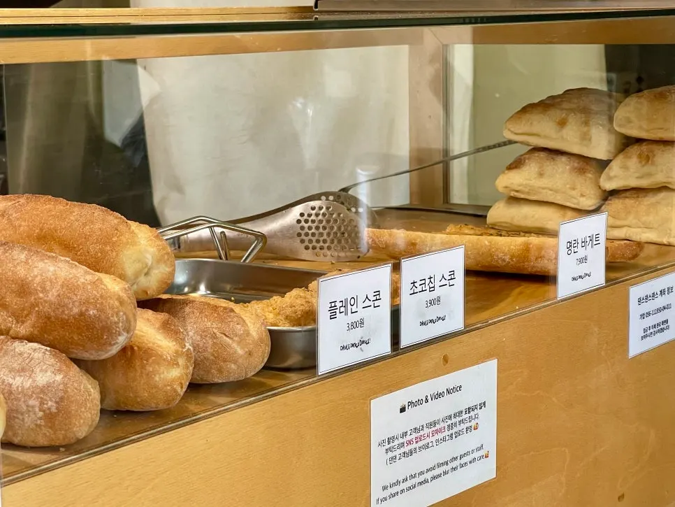 Scones and baguettes displayed in the bakery case