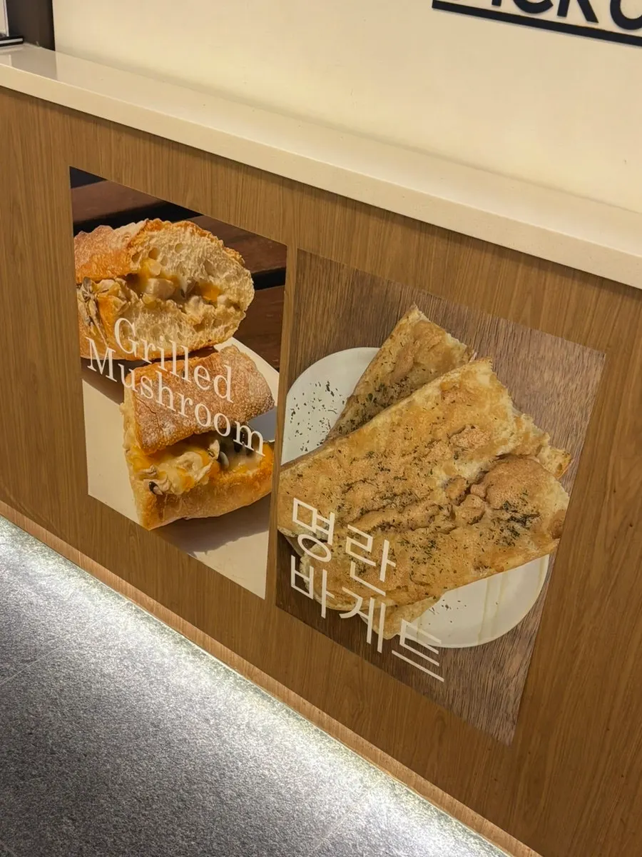Menu sign featuring hot ham and cheese and other items