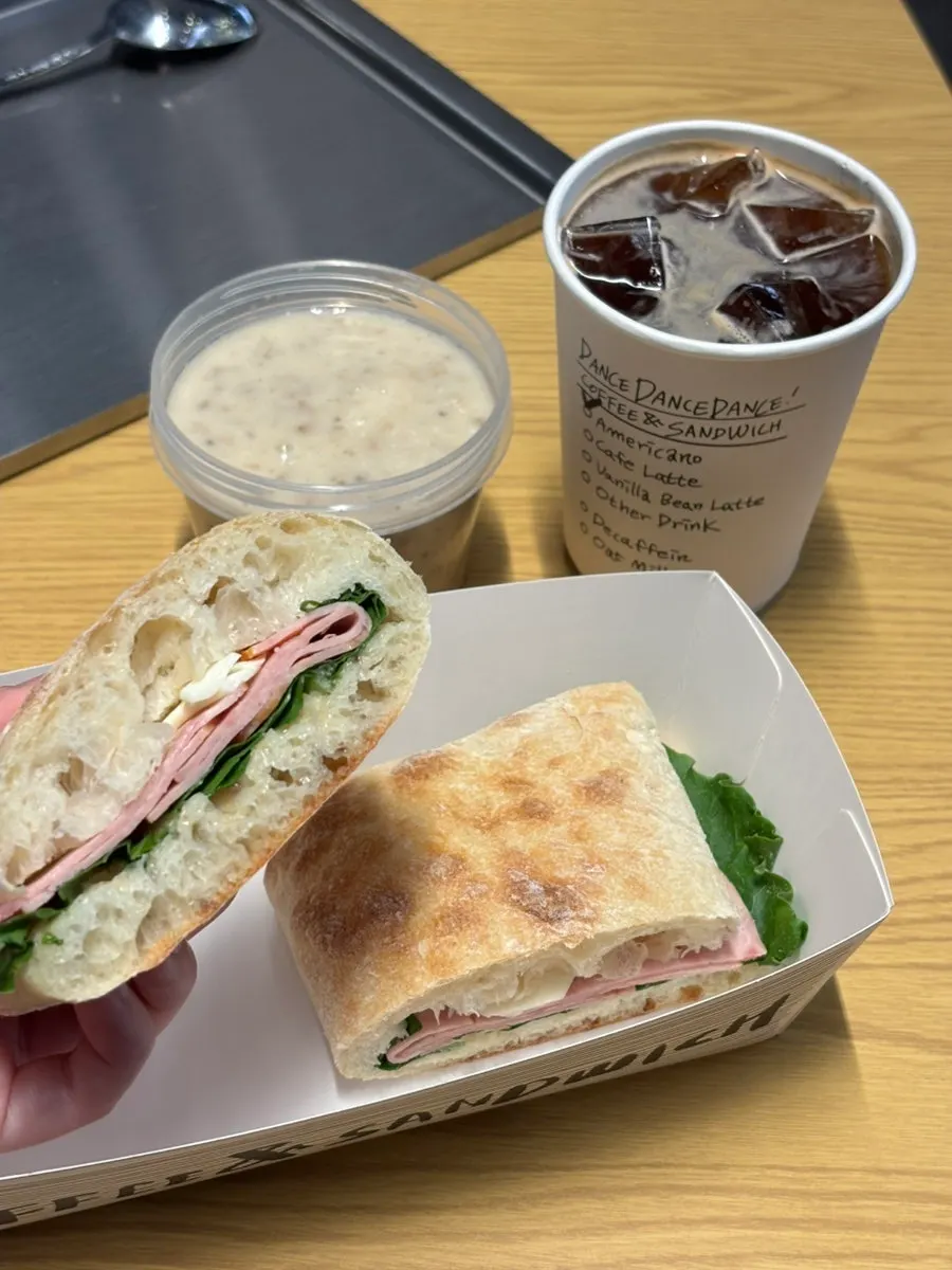 Half-eaten ciabatta sandwich with soup