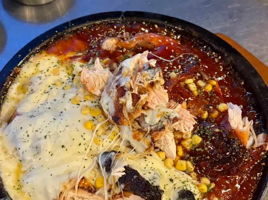 Whole chicken breast carved by a staff member