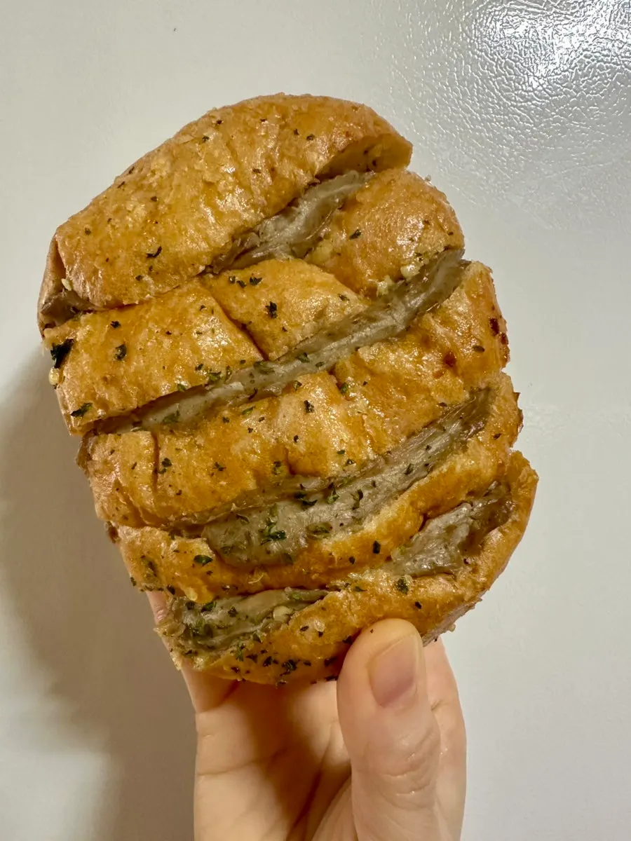 Cross-section of a bitten piece of garlic bread