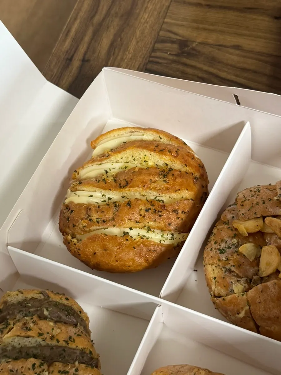 Cross-section of garlic bread packed with cream cheese