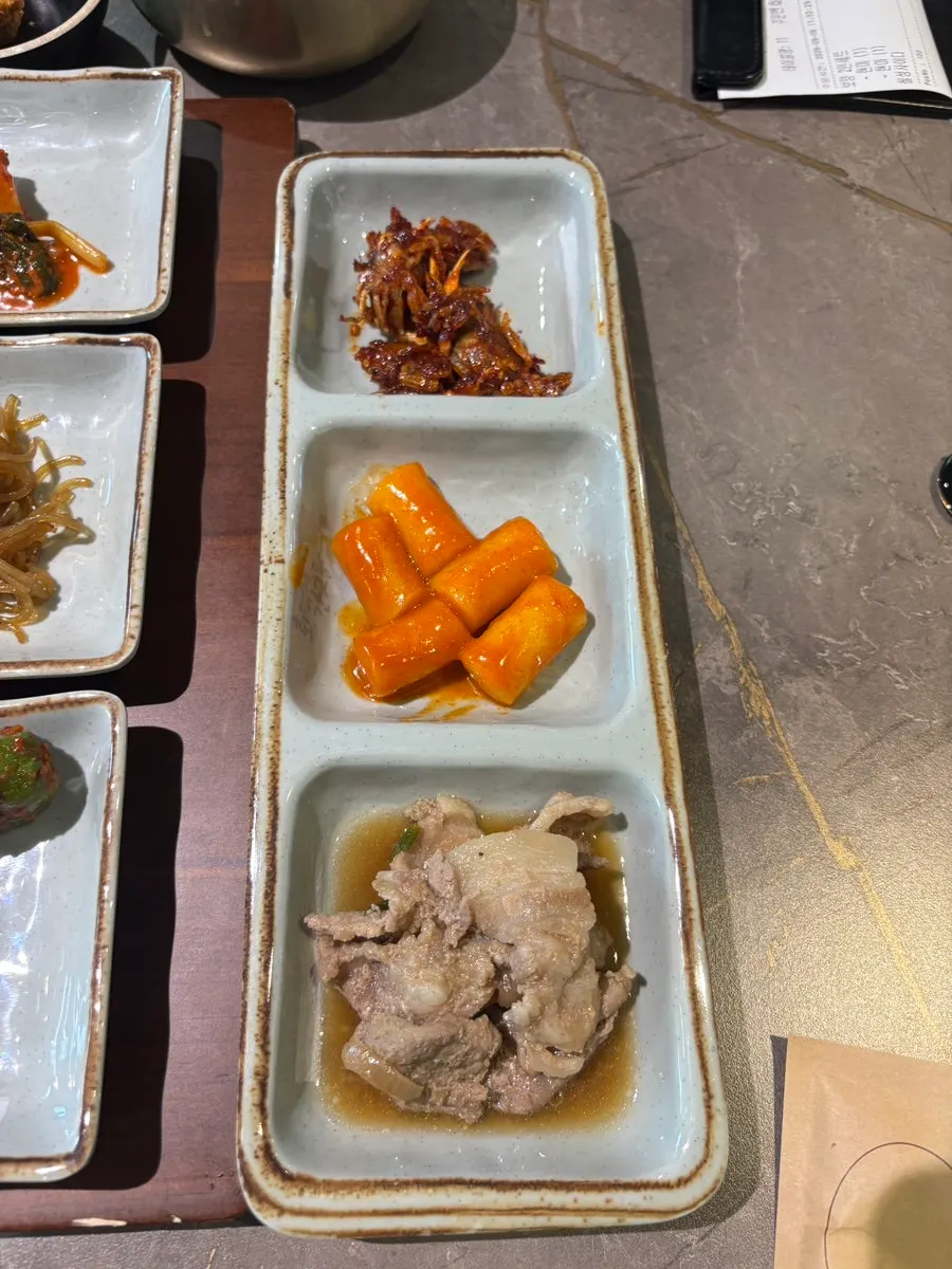Table setting with side dishes and soybean paste stew